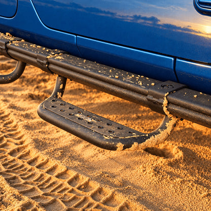 Black side step mounted beneath the rock rail of a blue Jeep Gladiator JT on sand.