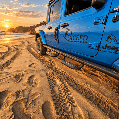 Side steps beneath the front and rear doors of a blue Jeep Gladiator JT on sandy ground.