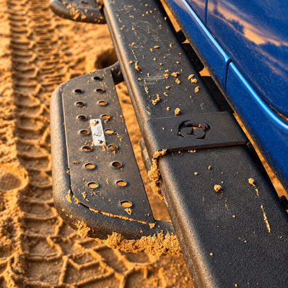 Top view of a side step and its mounting brackets over the rock rail on a blue Jeep Gladiator JT.