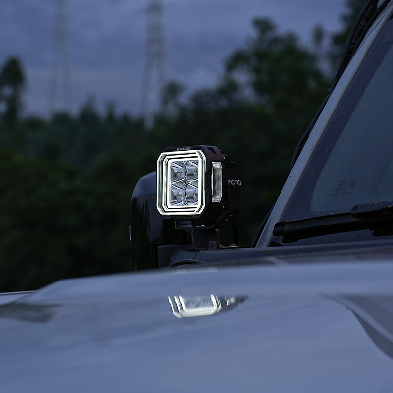 SUPAREE HYPER 5 LED pod light with white backlighting installed beside the windshield.