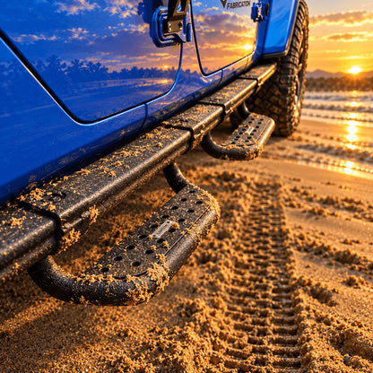 Blue Jeep Gladiator JT with side steps parked beside the water at sunset.