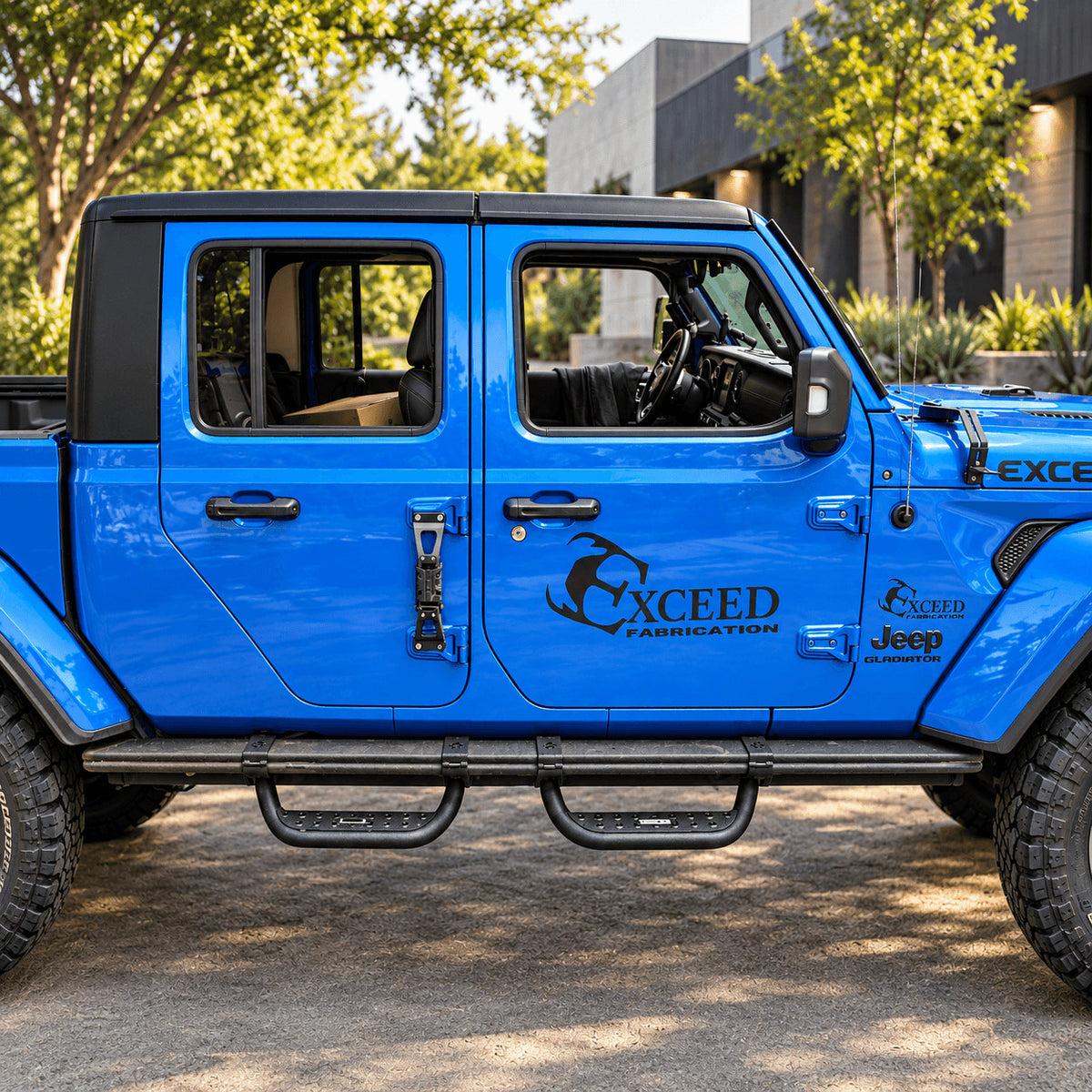 Blue Jeep Gladiator JT with side steps parked beside the water at sunset.