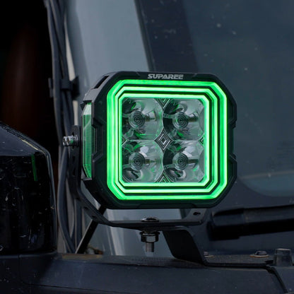 Close-up of a SUPAREE HYPER 5 RGBW LED pod light with green three-layer backlighting.