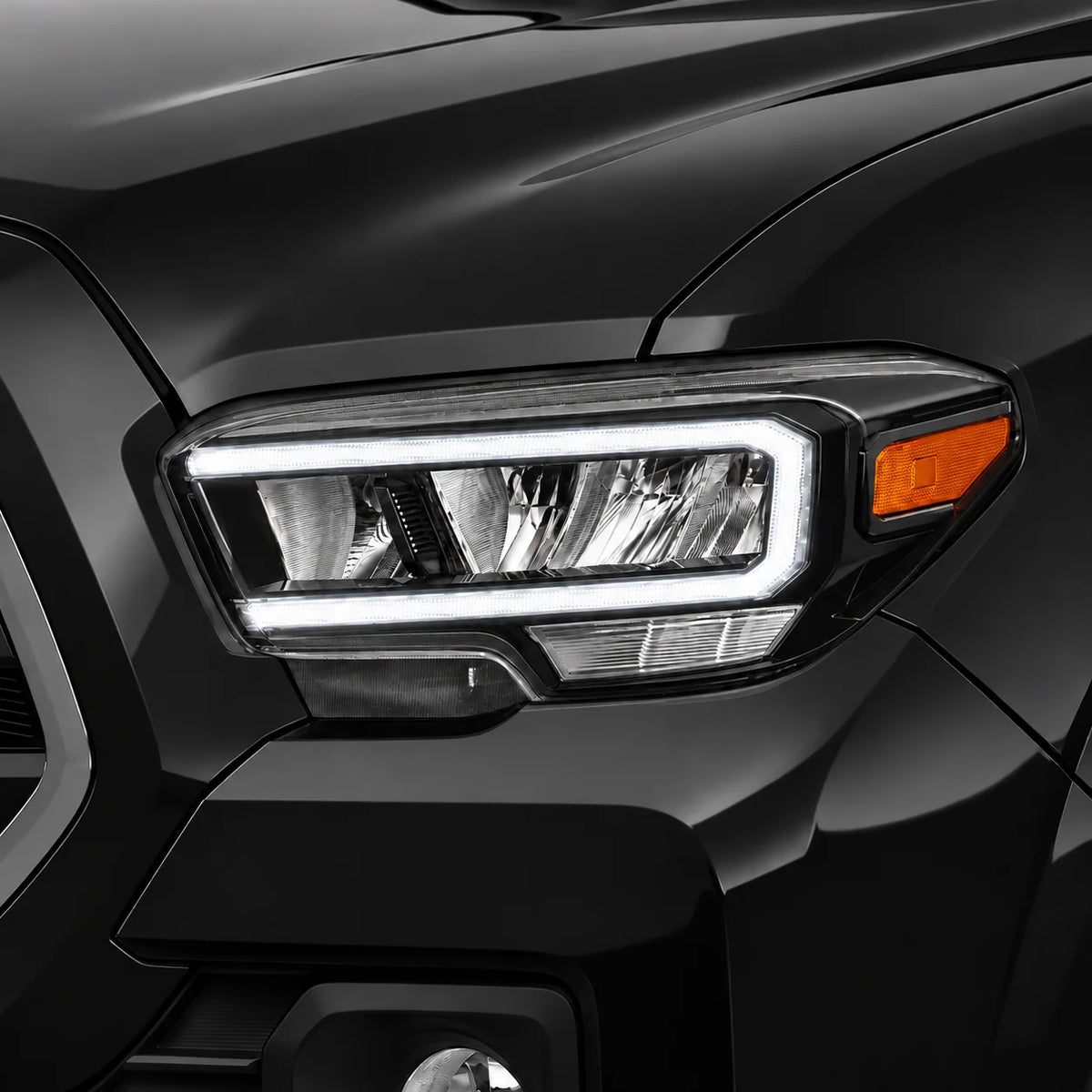 Toyota Tacoma LED headlight with only the white daytime running light illuminated.