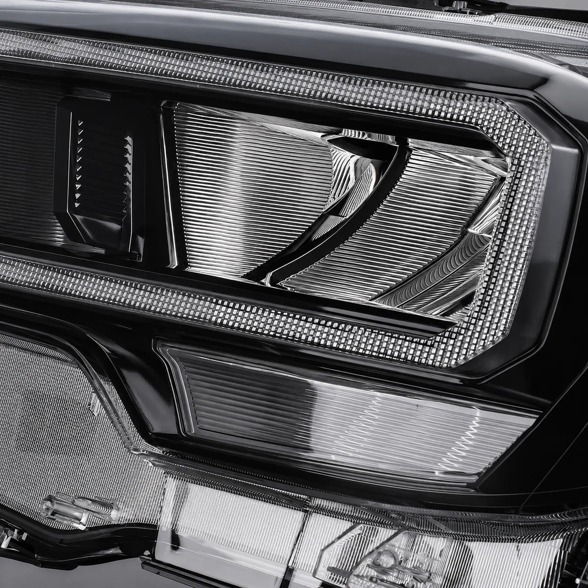 Close-up of the clear Teijin polycarbonate lens on a Toyota Tacoma LED headlight.