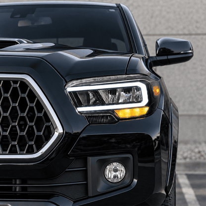 Animated Toyota Tacoma amber LED turn signal blinking while the white DRL stays on.