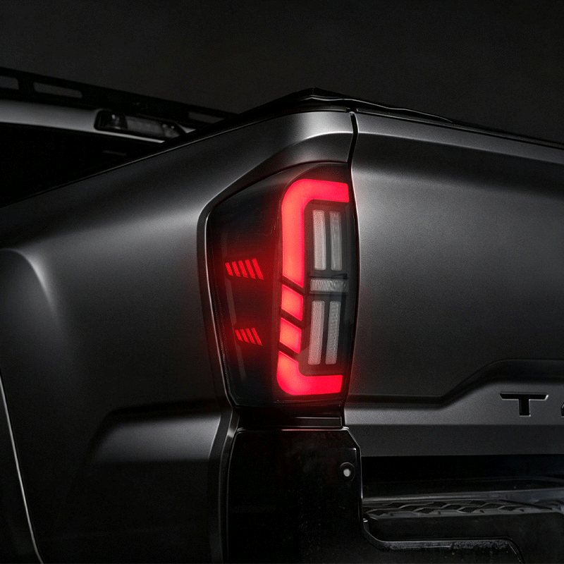 Animated amber sequential turn signal on a smoked LED tail light for 2016-2023 Toyota Tacoma.