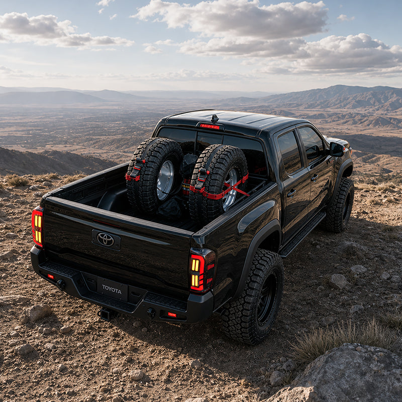 Smoked LED tail lights for 2016-2023 Toyota Tacoma shown on a black truck overlooking a rocky mountain trail.