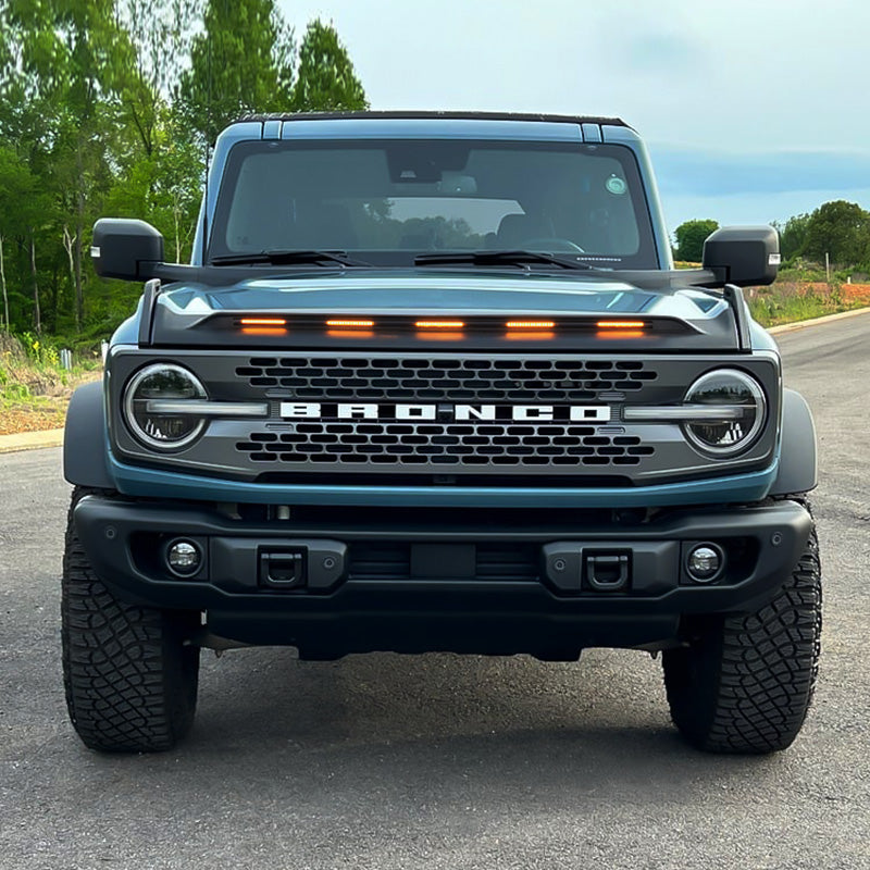 Bronco LightShield hood protector with amber LED lights featured on Ford Bronco customer vehicles in multiple outdoor scenes