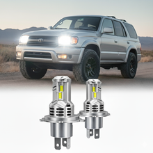 1996-2002 Toyota 4Runner H4 9003 LED Projector Headlight Bulbs shown installed on a silver 3rd Gen 4Runner SUV with off-road tires.