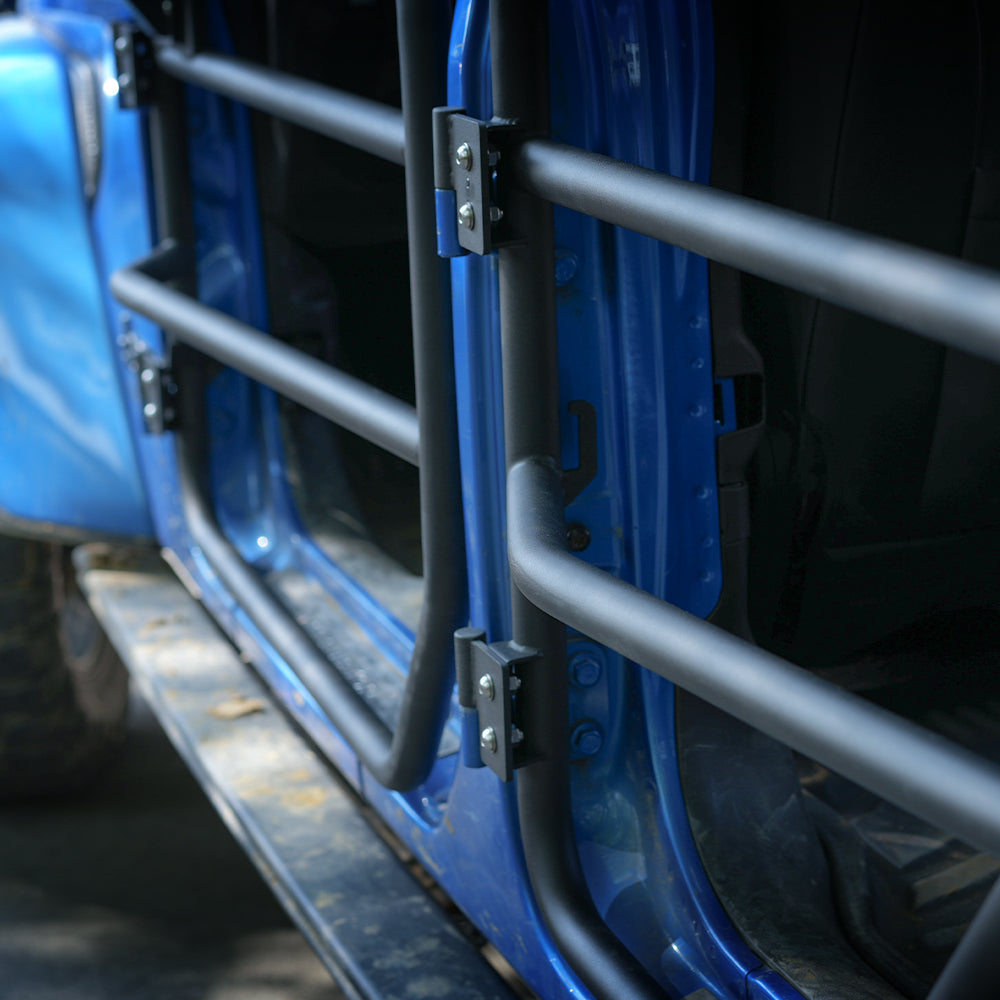 Close-up of SD1 SERIES tube door hinges and mounting plates installed on the vehicle