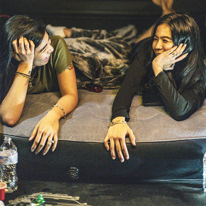 Truck Bed Air Mattress - Tundra Fit | Inflatable, Durable. Two women relaxing on a 5.5FT inflatable air mattress in a Toyota Tundra truck bed, ideal for camping.