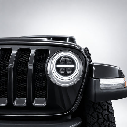 Close-up of a 9-inch Jeep RGB LED headlight with white dual halos, center DRL bar and four projector lenses