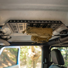 Jeep Wrangler JL overhead molle panel fully loaded with tactical pouches, CB radio, and off-road gear