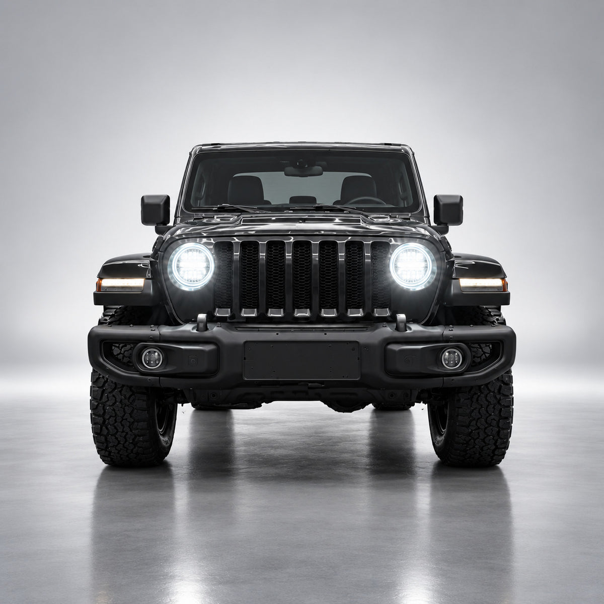 Black Jeep Wrangler JL front view with bright white 9-inch LED headlights