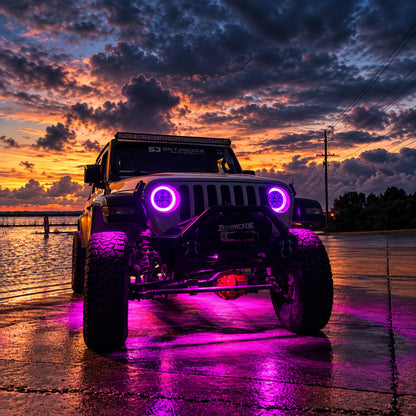 Modified Jeep Wrangler JL at sunset with purple RGB LED headlight halos, three-quarter front view