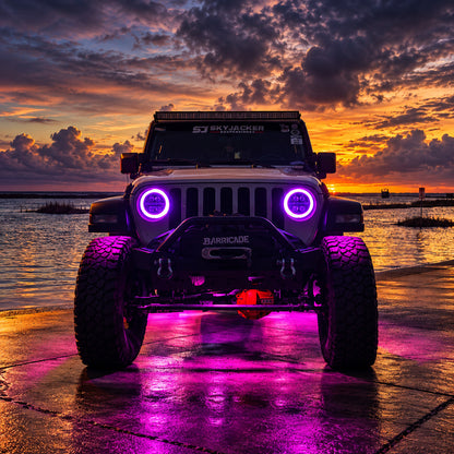 Modified Jeep Wrangler JL at sunset with purple RGB LED headlight halos, centered front view