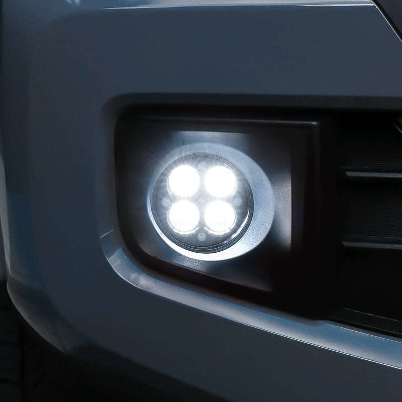 Close-up of aluminum housing LED fog lights for Toyota Tacoma showing clear lens and sturdy build