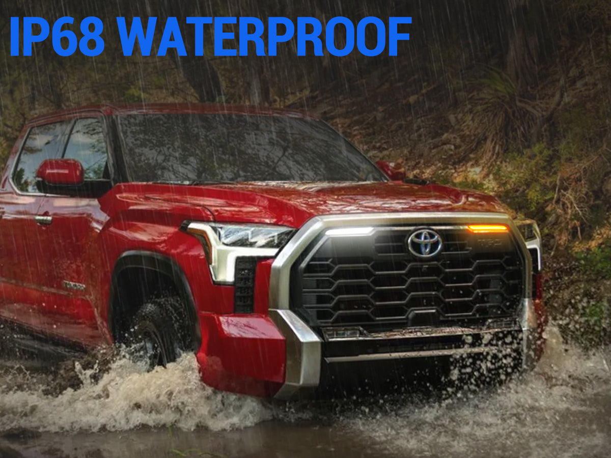 Toyota Tundra with grille lights driving through rain
